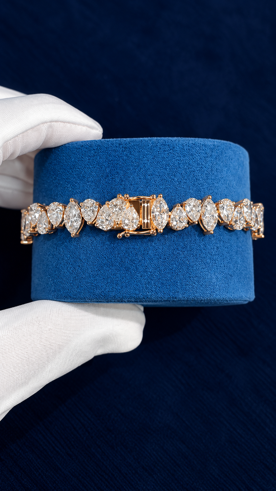 Custom pear and marquise bracelet on a blue velvet cushion, box clasp and safety catch shown