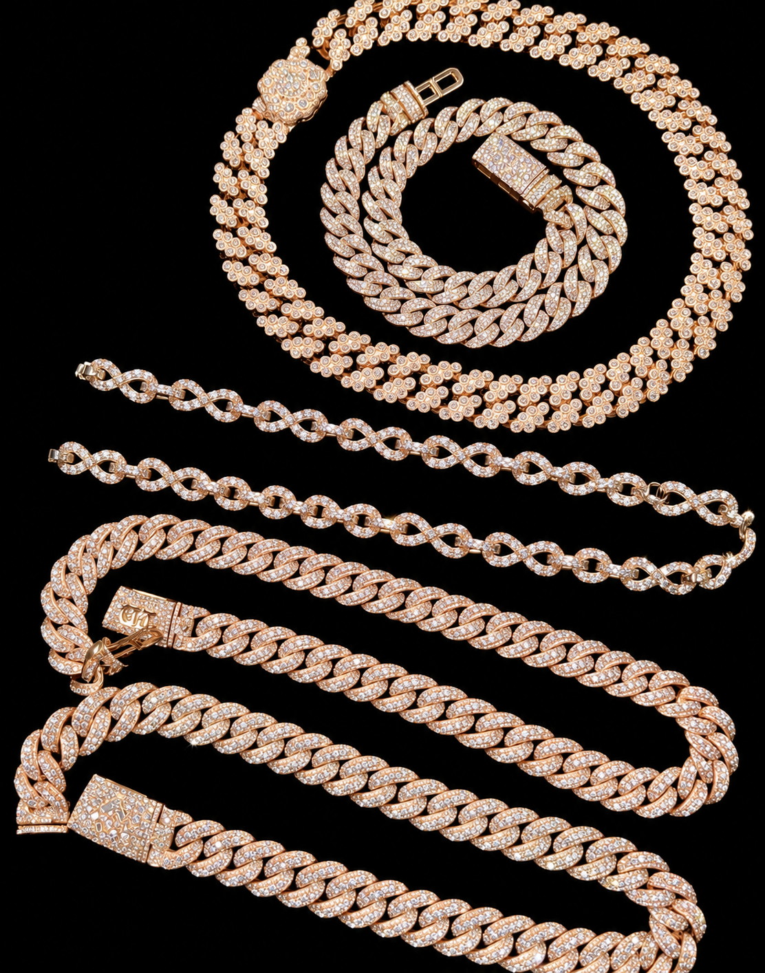 Iced out cuban link and tennis chains laid out on a black background